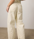 cream jeans with brown stitching