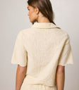 cream top with embroidered detail
