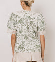 white blouse with green florals